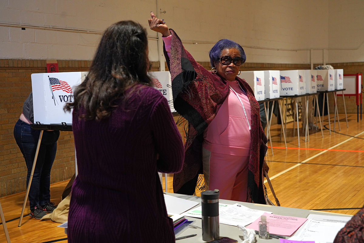 A woman snaps her fingers in a school guy after voting.